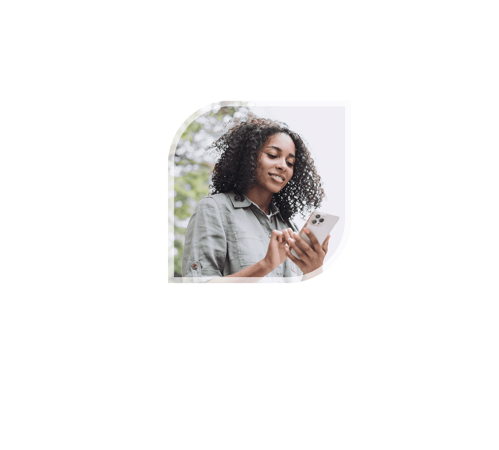 Woman smiling while looking at phone